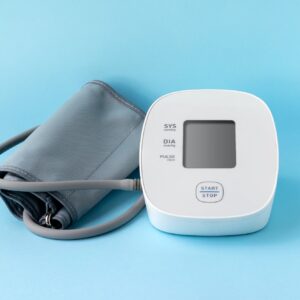 Automatic blood pressure monitor on blue background. Medical electronic tonometer